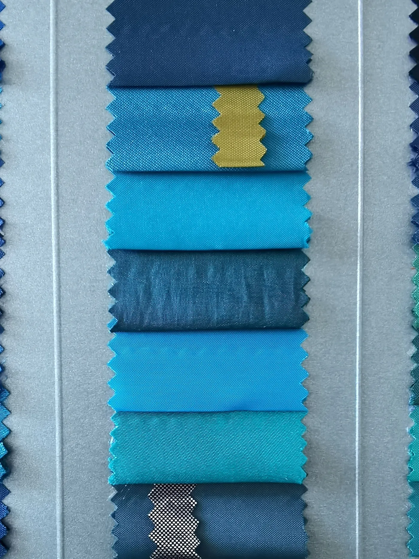 Blue fabric swatches arranged for color comparison and shade selection