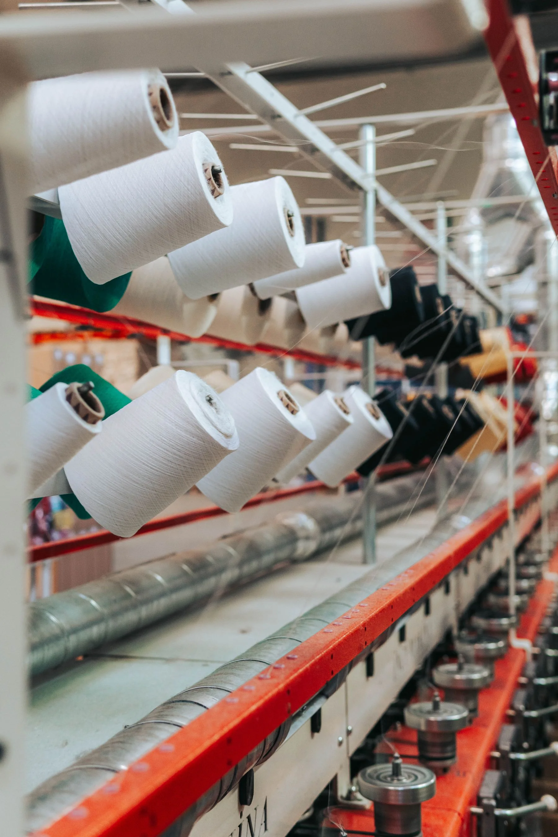 Thread spools feeding textile machinery during yarn production
