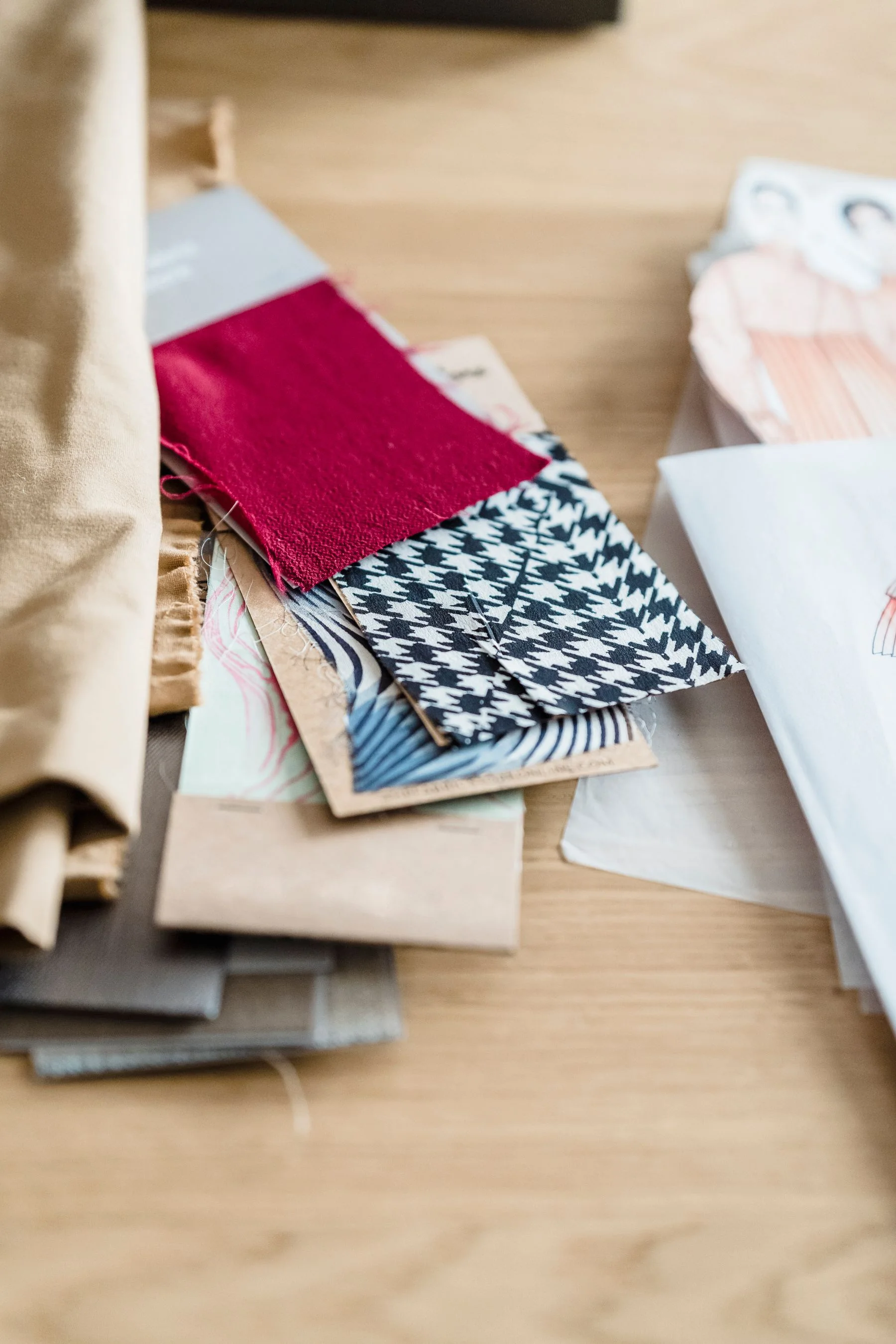 Fabric samples arranged on a design table for buyer review
